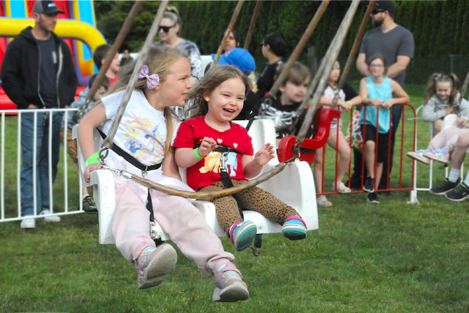 Keira (left) and Chloe Petula loved the carosel ride at the Shortreed Elementary Fun  Fair on Friday, May 23, 2025. (Heather Colpitts/Black Press Media)