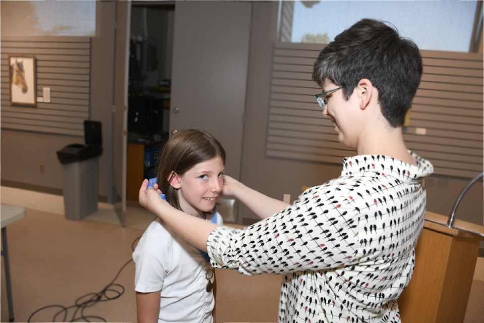 Remi DeRossi received her medal from community librarian Erica Braumberger during the wrap-up celebration for the Summer Reading Club on Aug. 29, 2025. 