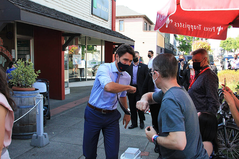 Justin Trudeau makes a campaign stop at the Hawthorne pub in Cloverdale Aug. 18 to support John Aldag’s bid to retake the riding of Cloverdale-Langley City after losing to Tamara Jansen in the 2019 federal election. Trudeau and Aldag hopped behind the bar to pour a few glasses of beer. (Photo: Malin Jordan)