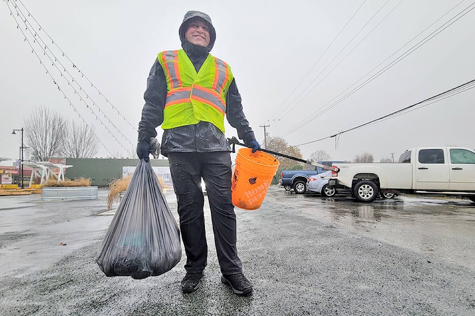 It disn’t take Andrew Sigalet long to fill a full trash bag during Sunday’s damp Aldergrtove cleanup. He was one of 12 volunteers who turned out despite the heavy rain. (Dan Ferguson/Langley Advance Times)