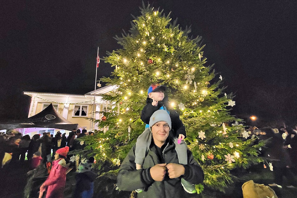 Jesse Rypstra and son Isaiah attended the tree lighting ceremony in Fort Langley on Saturday, Dec. 4, that Rypstra saved by stepping in at the last minute when the company that usually handles the lighting was trapped by flooding. (Dan Ferguson/Langley Advance Times)