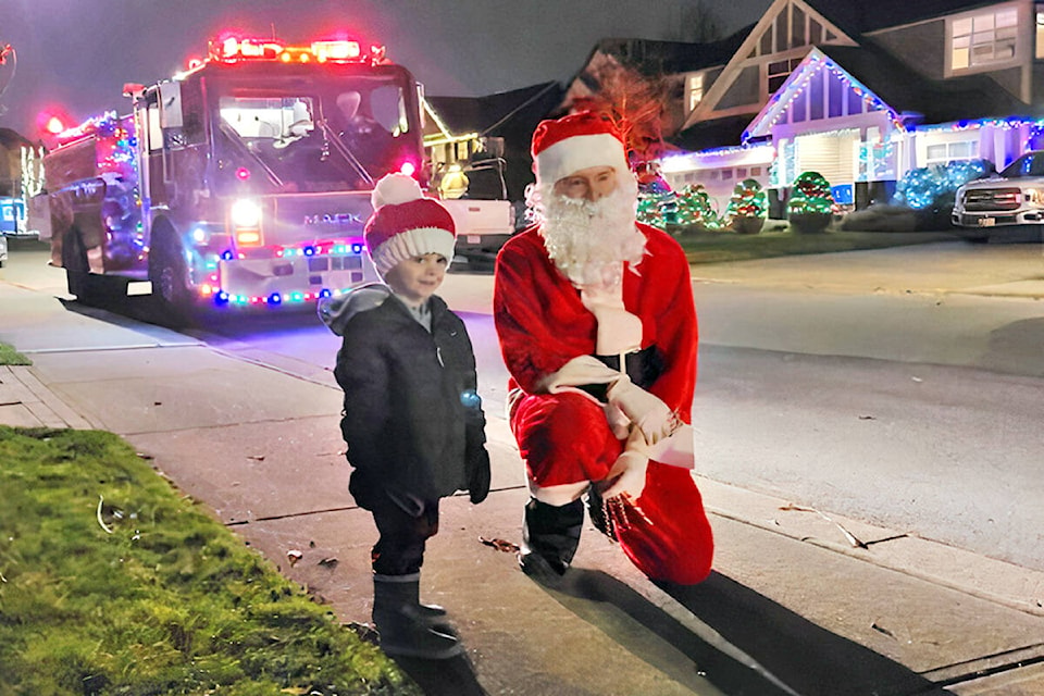 It took firefighters and Santa an hour longer than expected to complete the Aldergrove candy cane run on Friday, Dec. 17, because there more people than ever wanting to see the jolly old elf and make donations to the food bank. (Special to Langley Advance Times)