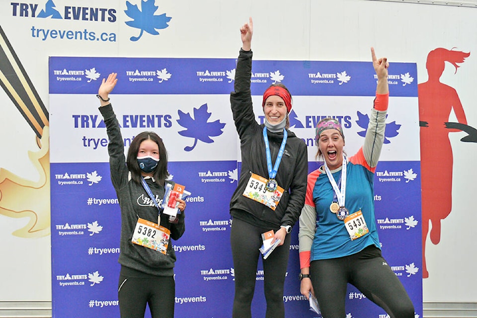 5K winners Brianna Kwan from Delta (2nd), with Marla Brown (1st) and Jessica Vink (3rd) from Chilliwack, celebrate at the Sunday, Feb. 20 return of the Historic Fort Langley Half Marathon and associated 10 and 5K races. (Dan Ferguson/Langley Advance Times)