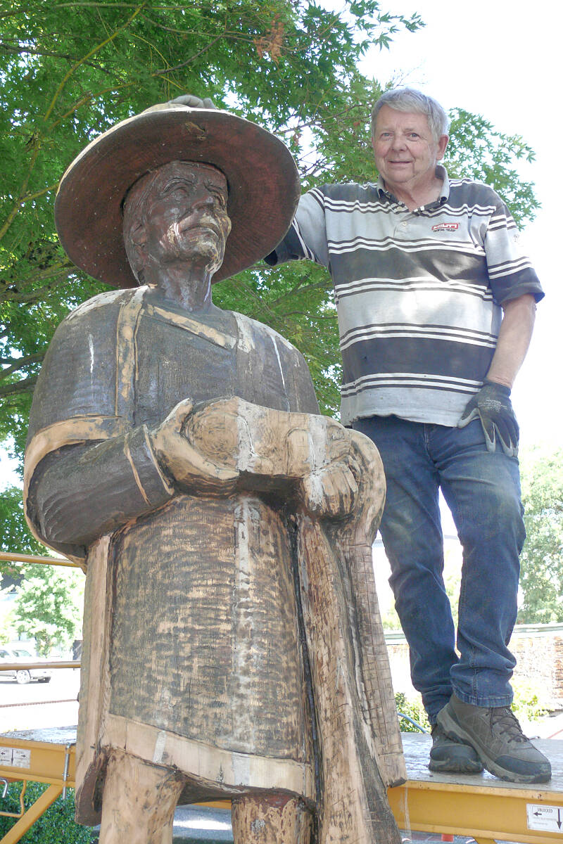 Victor Smith said it was a privilege to restore the iconic Pete Ryan statues in Langley City. On Wednesday, Aug. 17, he started working on the two Ryan statues of a fur trader and First Nations chief at Innes Corners. (Dan Ferguson/Langley Advance Times)