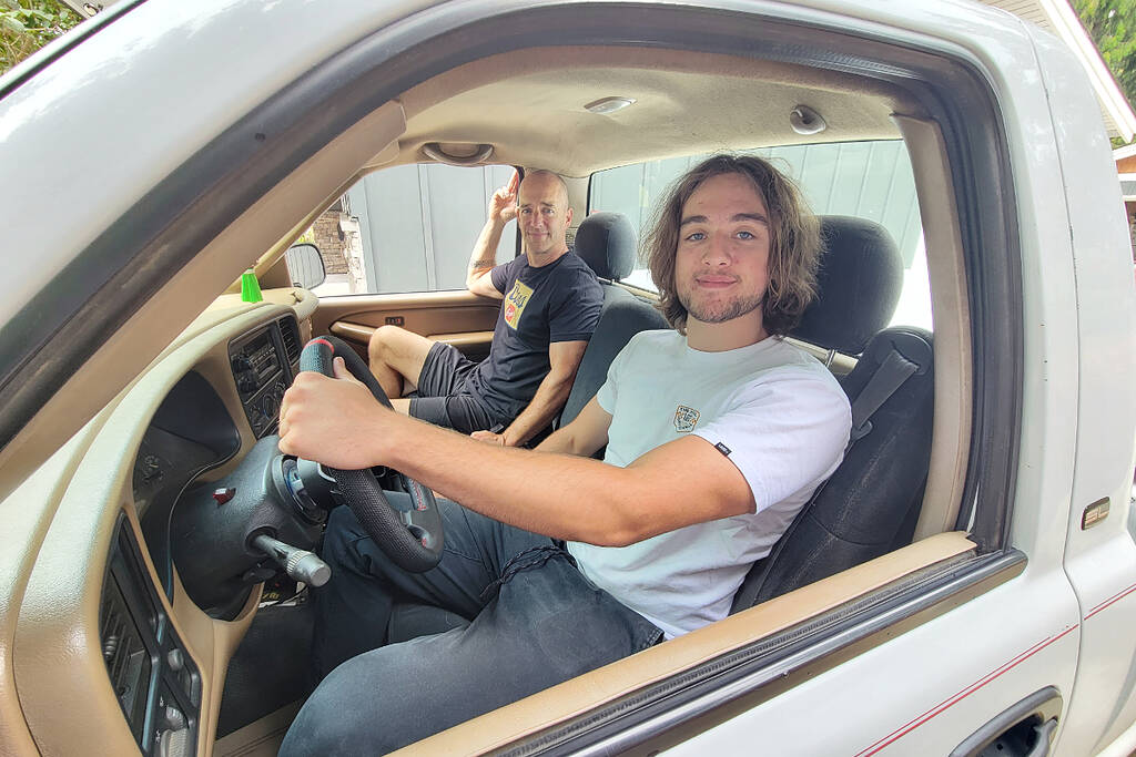 Brodie Johnstone (foreground) and dad Mark, long-time Cruise-In fans, have just completed their first custom vehicle project, swapping a stock V6 for a modified V8 in Brodies 1999 GMC Sierra 1500. (Dan Ferguson/Langley Advance Times)