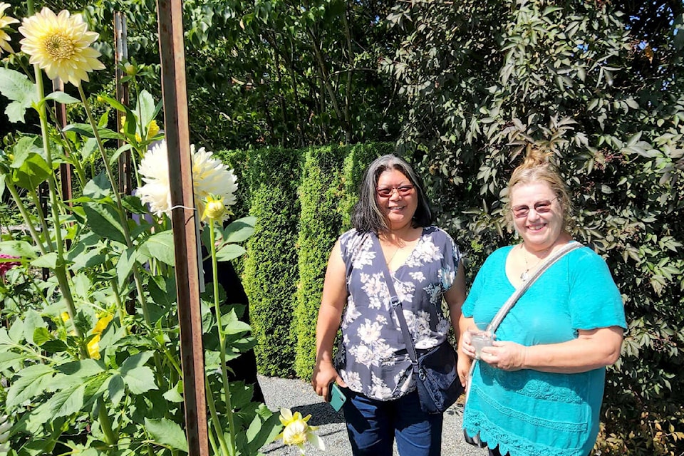 Valerie Low and Rae Desaulniers, members of the Langley Garden Club, recently toured a member’s dahlia collection. (Pam Erikson/Special to Langley Advance Times)