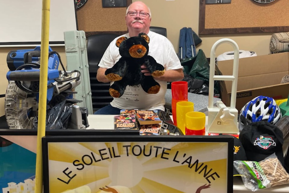 Vern Munroe, third vice-president of the Langley Elks, showed off a Teddy bear and a number of other items being sold off at a fundraising garage sale happening this Sunday. (Special to Langley Advance Times)