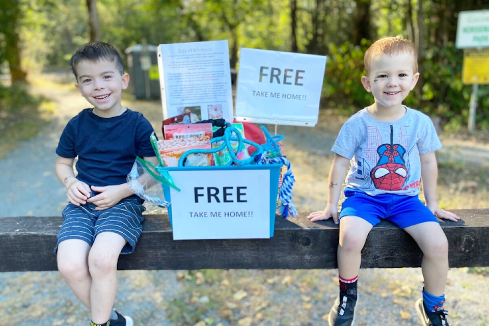 Bennett Warren, 4, and his brother Wyatt, 3, leave a box of free pet treats at at Horsemen’s Park in honour of their uncle Trent Edward Gibney for Suicide Prevention Month. (Special to The News)