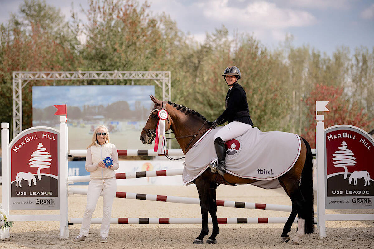 Aldergroves Kassidy Keith has felt a difference in her nine-year-old stallion, Fenelon WF won their first U25 event at tbird on on Thursday, Sept. 22, at the CSI3* BCHJA Fall Finale. The pair stood for the winners presentation with tbird CEO Jane Tidball. (Quinn Saunders/tbird)