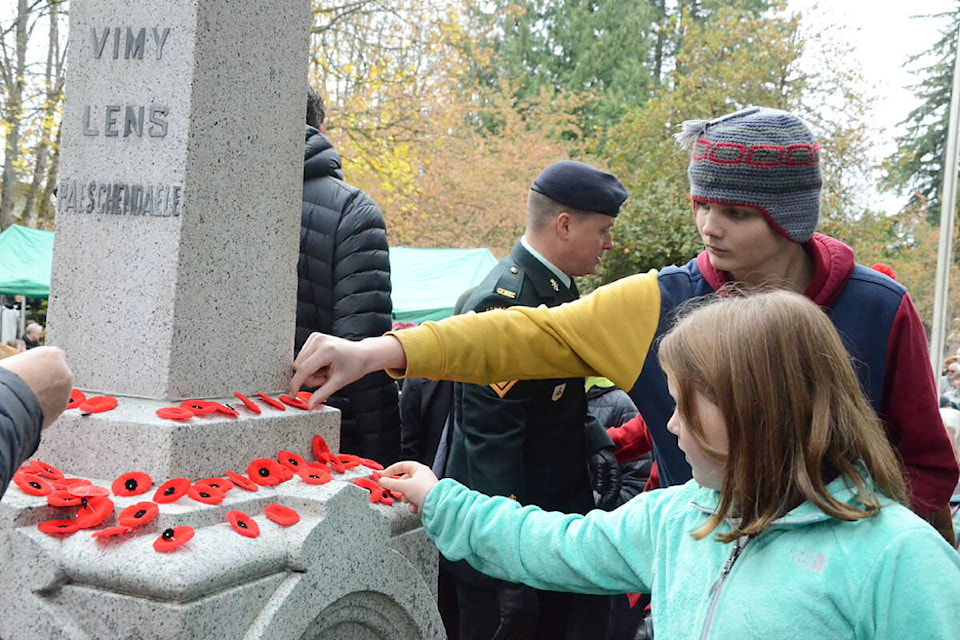 After the Remembrance Day service at the Fort Langley cenotaph, people placed their poppies on the plinth. (Matthew Claxton/Langley Advance Times)