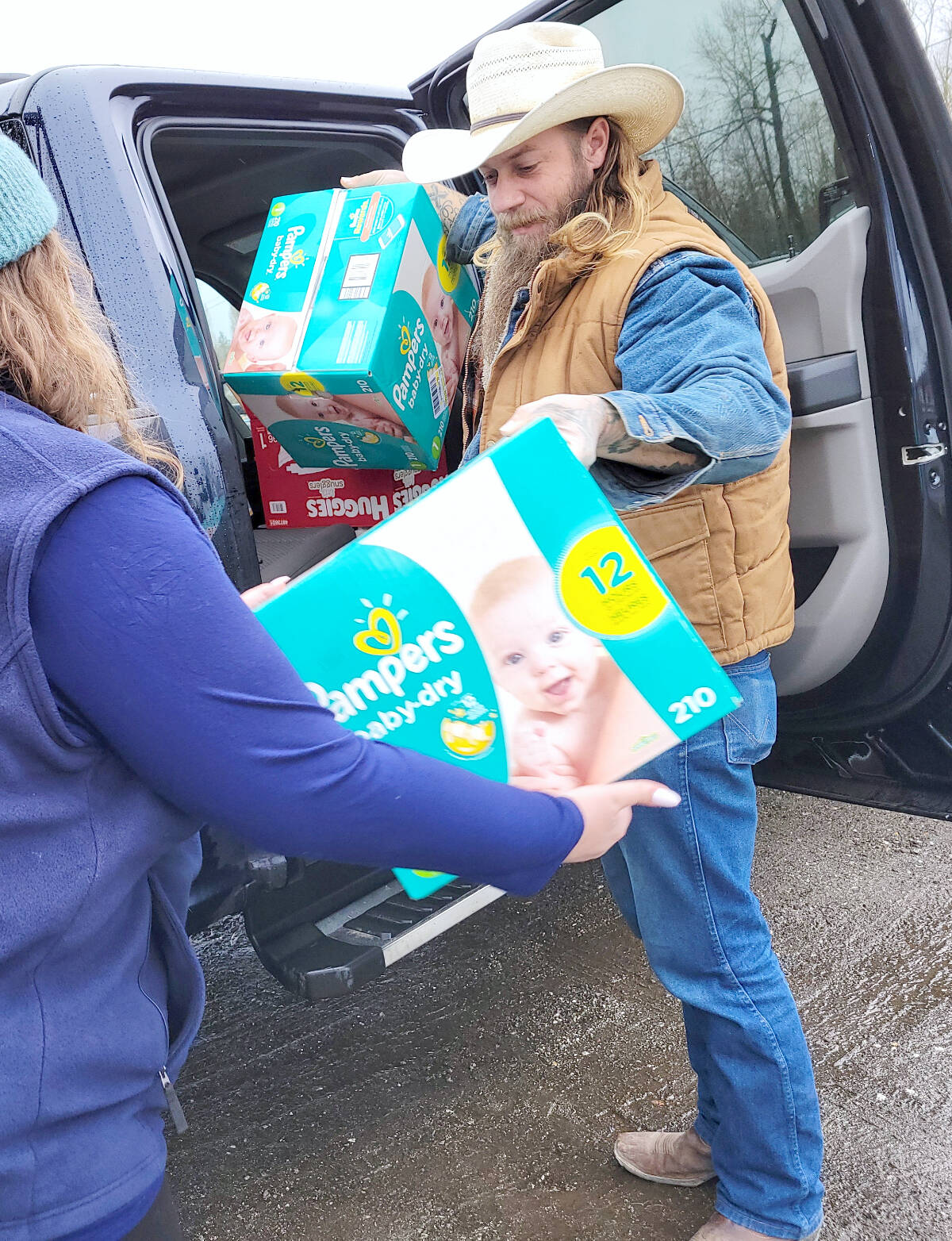 Dayton Way-White dropped off some surplus baby supplies Sunday, Dec, 11 at Langley Events Centre. The Langley part of the Basics for Babies campaign raised $5,700 and overflowed a cube van with supplies. (Dan Ferguson/Langley Advance Times)