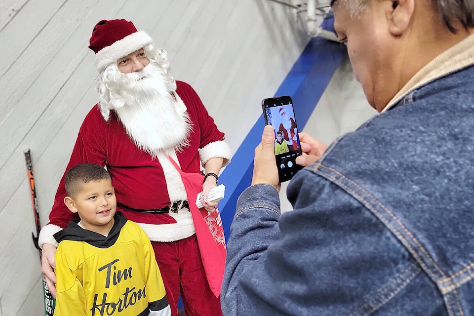 North Langley resident Ryder, 7 had his picture taken with Santa by grandfather Louchie Harry, who was visiting from Powell River, at the Dec. 11 Santa Skate organized by Langley Minor Hockey Association at George Preston arena. (Dan Ferguson/Langley Advance Times)