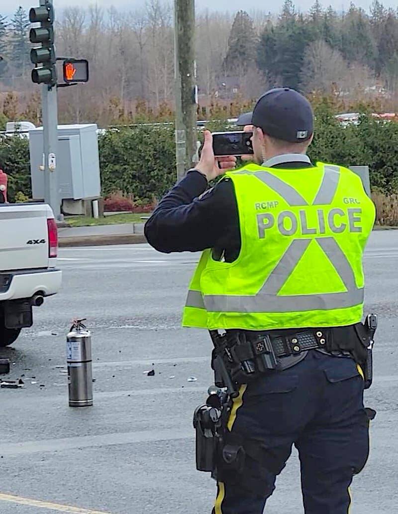 An RCMP officer took photos of the crash scene at 260th and Fraser Highway on Saturday, March 11. No serious injuries were reported in the two-vehicle crash. (Dan Ferguson/Langley Advance Times)