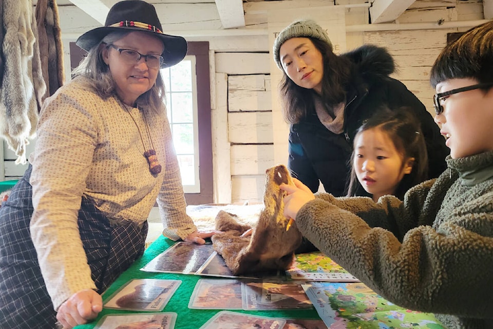 At Historic Fort Langley, Anna Birnie gave Maple Ridge mom Mia Shin, with daughter Haru, 7, and son Haju, 8, a chance to handle actual fur pelts like the ones from the days of the fur trade on Sunday, March 19 Fort Langley National Historic Site on Sunday, March 19. Spring Break at the fort continues until Sunday, March 26. (Dan Ferguson/Langley Advance Times)