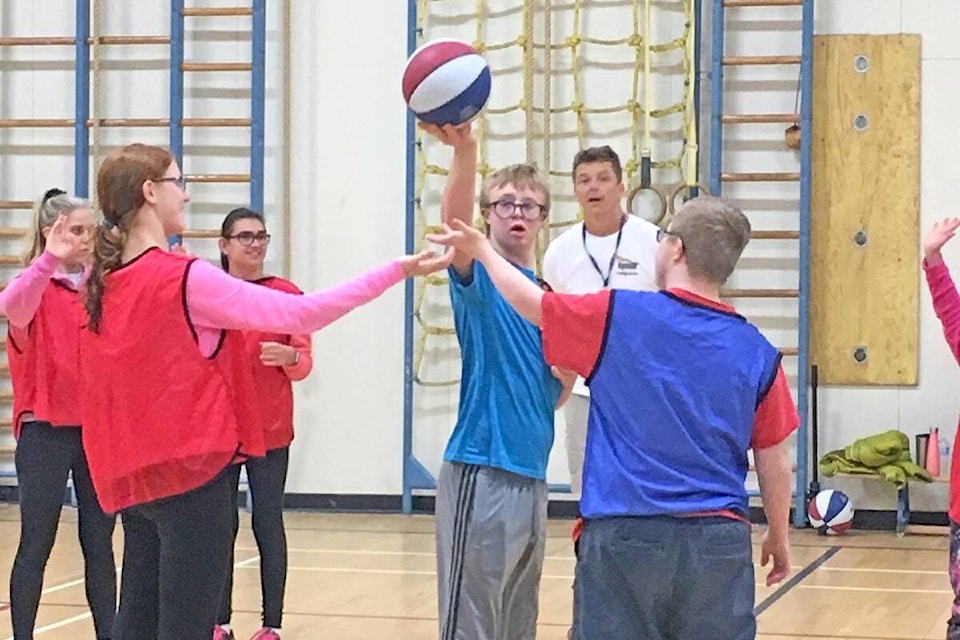 Jacob Brauckmann referees a basketball game during one of the Sport Start nights that were held at Jessie Lee Elementary in South Surrey for five years. Coaches are now launching a program that aims to teach basic motor skills to two- to six-year-olds with intellectual disabilities. (Contributed file photo)