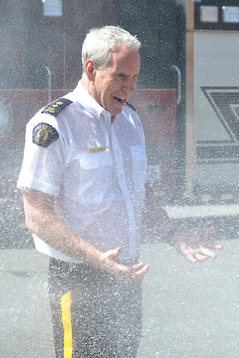 This is what happens when you lose a contest with the fire department. Langley RCMP Supt. Adrian Marsden was hosed down Monday morning, June 5, after the detachment came second in a blood donation challenge. (Dan Ferguson/Langley Advance Times)