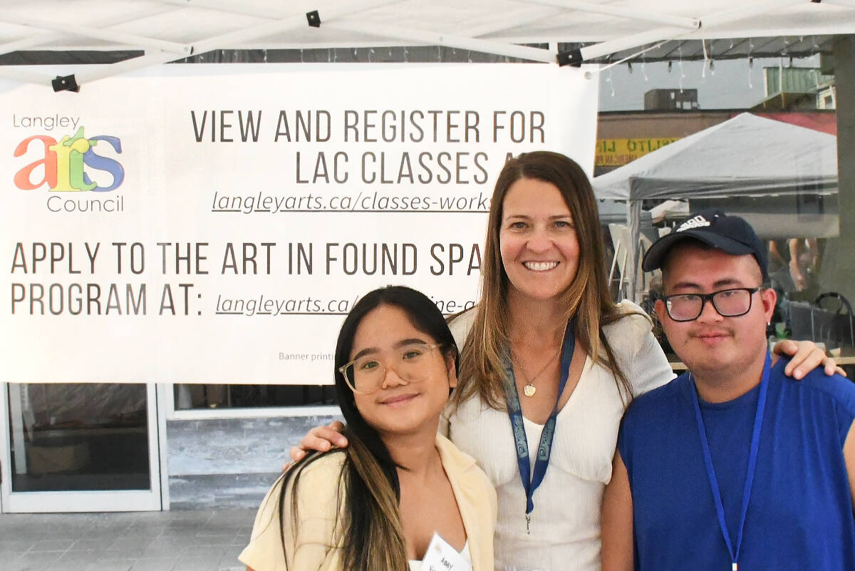 Nicole Hutton (centre) and members of the Langley Arts Council were providing information on free and paid programs during the Arts Alive Festival on Saturday, Aug. 19. (Kyler Emerson/Langley Advance Times)