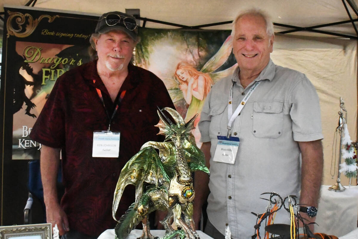 Ken Johnson and Bruce Kilby, local novelists, were doing book signing at the Arts Alive Festival on Saturday, Aug. 19. (Kyler Emerson/Langley Advance Times)