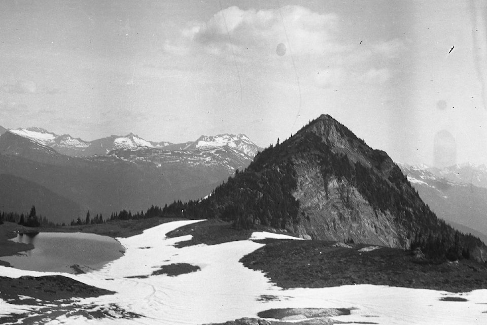 This historic photo is of the small alpine lake on slope of Mount Sproat north of Arrowhead, ca. 1930s-1940s.

Notes by Charlie Slade: "Little lake on E. side of Mt Sproat. Just to right of lake is where I saw the bear. Incomappleux Mtn. In distance, just to Left of rocky knob in foreground.

To left of picture is mountain where the Teddy Glacier is. I was up to top of this mountain last week. It is at the head of Sable Cr.' Slade, a BC Forest Service ranger, was mauled by a grizzly here in August 1941."

