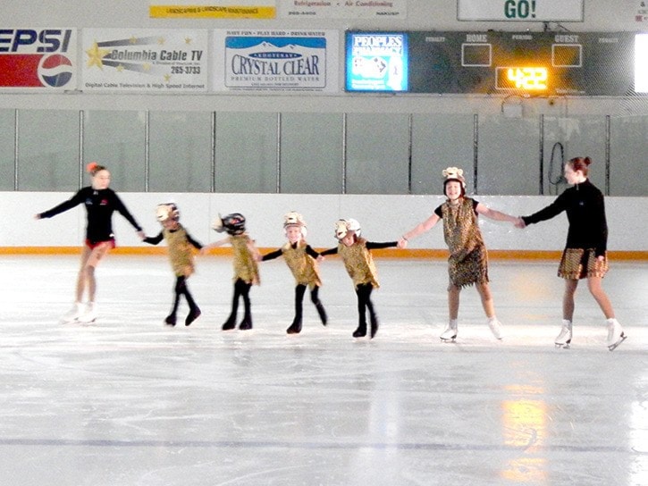 The CanSkate group performs a pinwheel while skating to Tarzan.