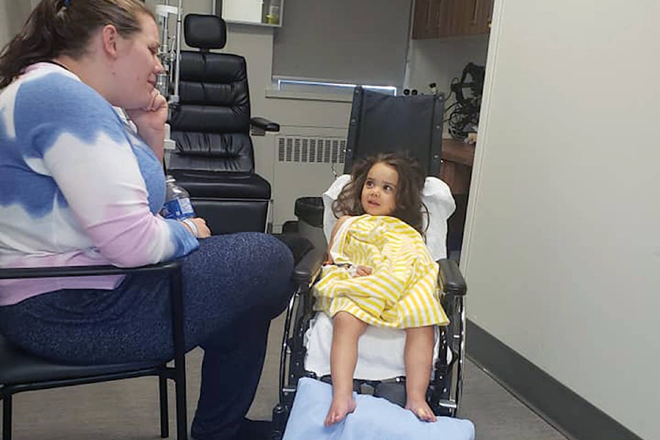 Melissa Radmore and Malia, at an eye exam after she was diagnosed (Courtesy Radmore family)