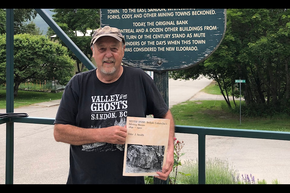 Peter Smith holds a copy of Silver Rush: British Columbia’s Silvery Slocan 1891-1900 outside the Silvery Slocan Museum in New Denver. The book has been years in the making. Photo: Judith Maltz