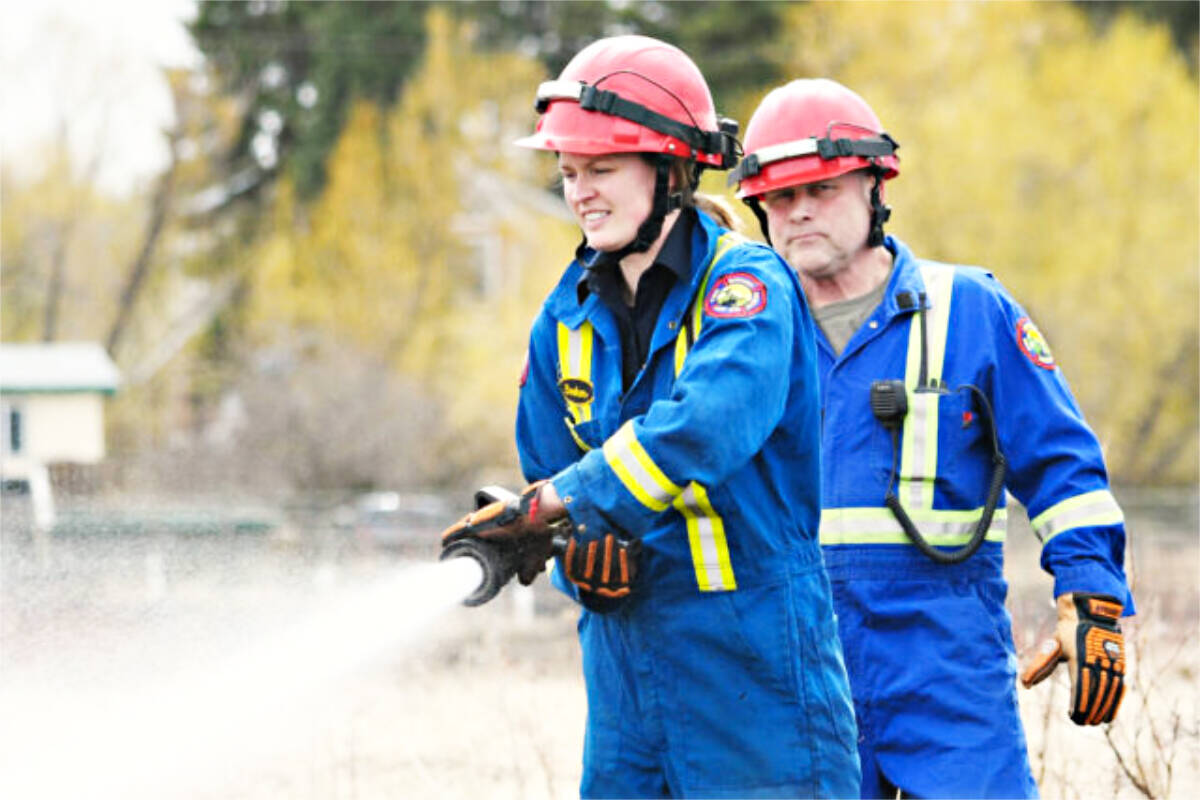 Kirby Booker puts out a grass fire. (Karen Powell file photo)