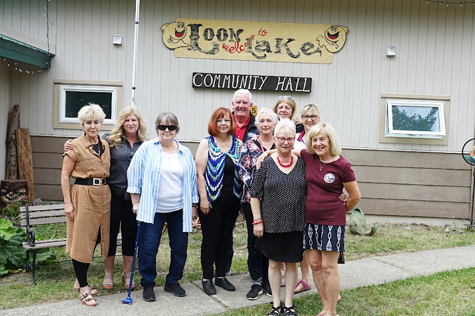 (from l) LLCRAS board members Gail Smith and Brenda Harrison (at front); board members Tanis MacAulay, Kimm Davis, and Sandy Eby; project coordinator Lois Harper; and board members Mary Ellen Graf, Maureen Morris, and Moira Passly with TNRD Area 'E' director Jim Smith outside the newly-renovated Loon Lake Community Hall on June 29.