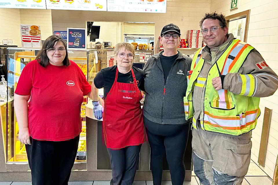 (from l) Ashcroft Travel Centre employees Becky Appleby, Tammy Whatman, and Nancy Rainville with Ashcroft Fire Rescue chief Josh White.