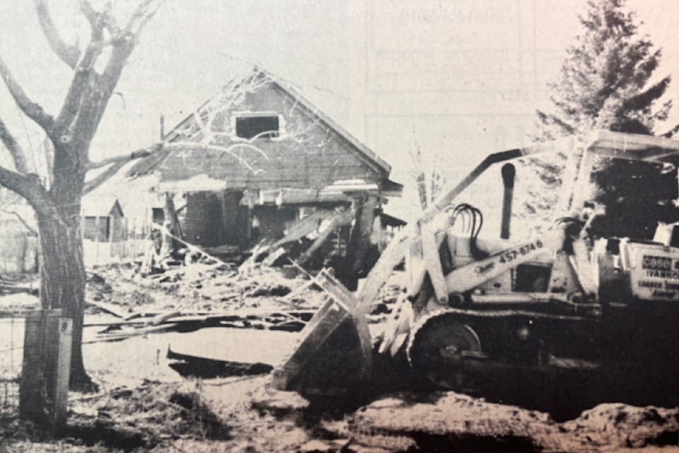'Another Old Building Being Demolished In Ashcroft' (April 9, 1975): 'Pictured is the former Godau home being razed to make way for the new Ashcroft Library at the corner of Second and Brink. Construction of the building will begin about the middle of April. Ivanhoe services is doing the demolition work.'