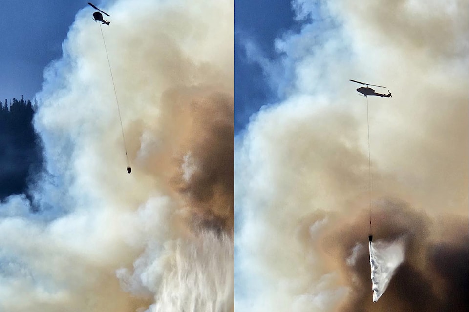 A helicopter drops water on the Sailor Bar wildfire near Yale on the afternoon of Sunday, Aug. 24.