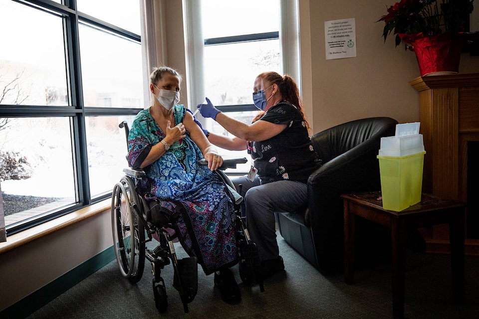 A mother and daughter in an Interior Health care home, who’s names are being withheld due to privacy, receive their COVID-19 vaccine together. (Photo courtesy of Interior Health)
