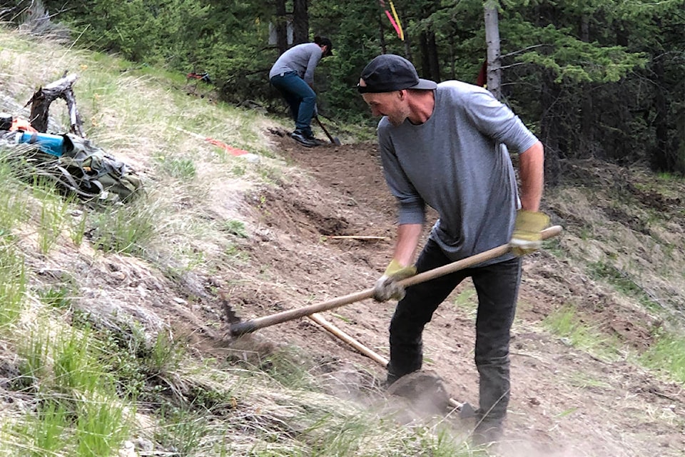 Danny Gorham and Josh St-Amour work on the new mountain biking trail that will end at the top of Jesmond Mountain. (Photo submitted)