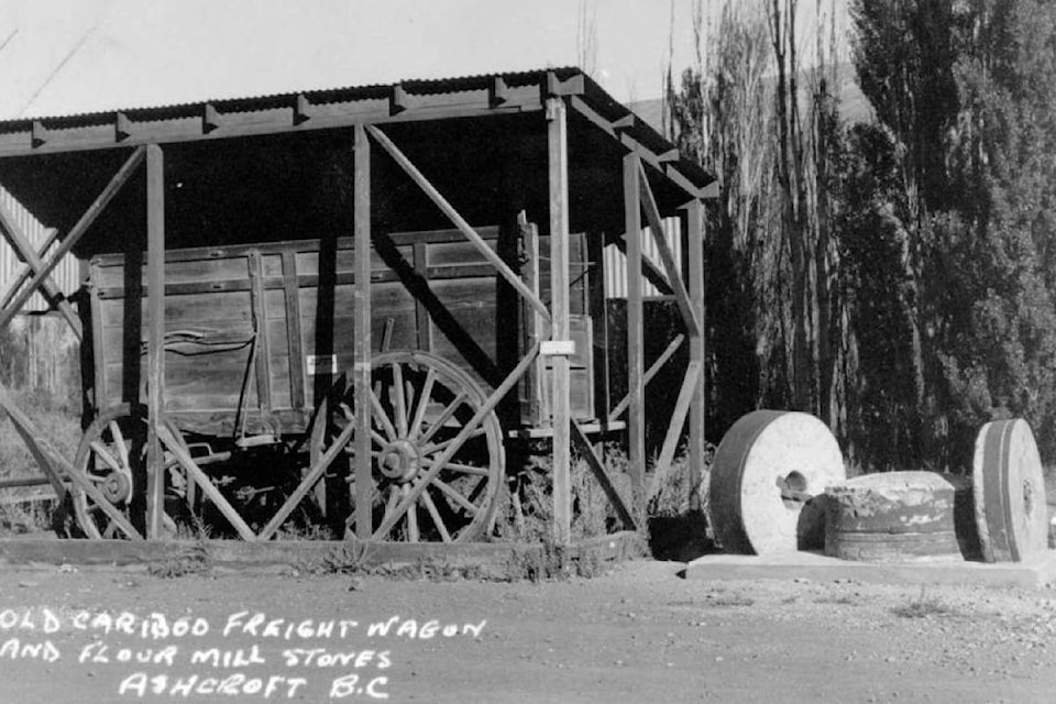 An undated photograph from c. 1946 shows the Harper’s Mill millstones beside the historic freight wagon in Ashcroft. (Photo credit: Ashcroft Museum and Archives)