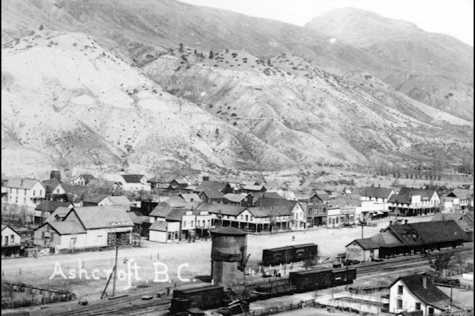 In 1897 there were calls to establish a reading room in Ashcroft, which would ‘improve this place’. The building ‘between Mr. Foster’s and the Drug Store’ — the small white building above the ‘B.C.’ in this photo from about 1912 — was suggested as a suitable location. Foster’s General Store is the large building to the left of it, and Clement’s Drug Store is the first of the two two-storey false-fronted buildings to the right; R.D. Cumming’s General Store is the false-fronted building closest to the corner of Railway and 4th (where ReMax Realty is now located). (Photo credit: Ashcroft Museum and Archives)