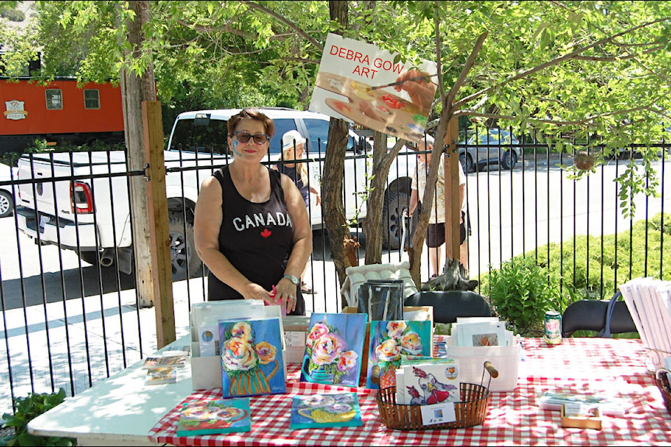 Ashcroft artist Debra Gow and some of her work at the opening of the Art Garden at The Bloomin’ Paintbrush in July. (Photo credit: Barbara Roden)