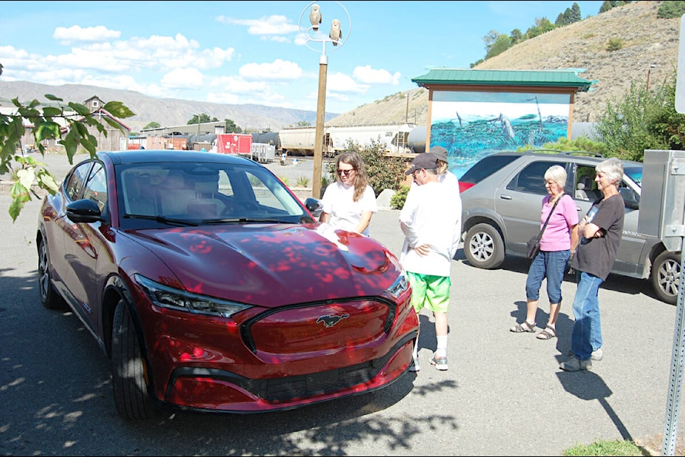 Onlookers get a demonstration of the features on a Mustang Mach-E in Ashcroft on Aug. 15. Two Level 2 chargers will be going in at the parking lot of the Heritage Park later this year. (Photo credit: Barbara Roden)