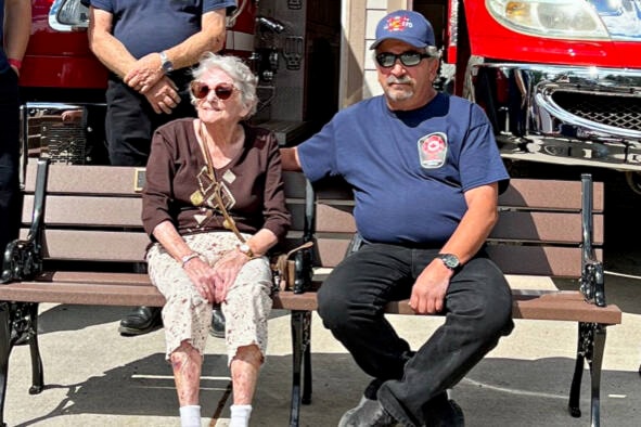 (seated) Anita Donovan and Loon Lake firefighter Franko Borri. (Photo credit: Brenda Borri)