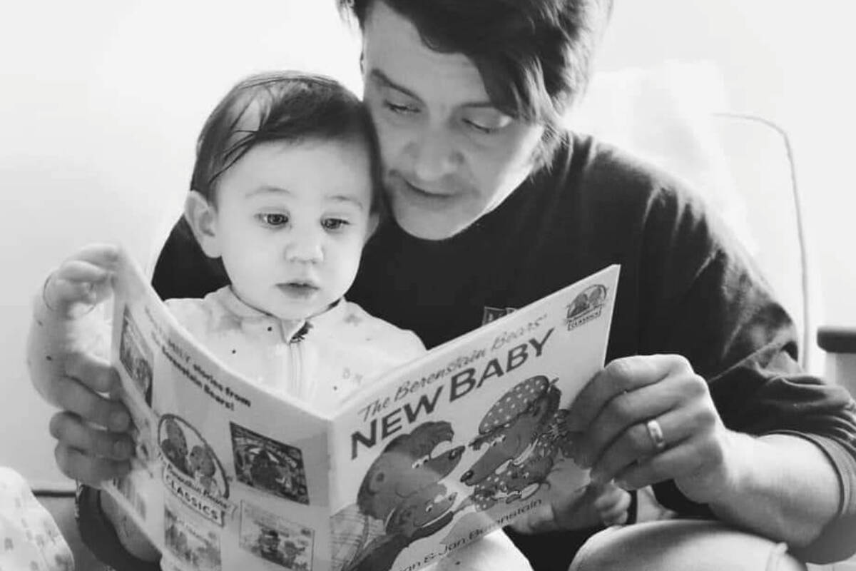 Nelsons Birkley Valks reads a story to his son. Valks was set to host a drag story time at the Nelson Public Library on Saturday, but the event has been postponed following online protests. Photo: Submitted