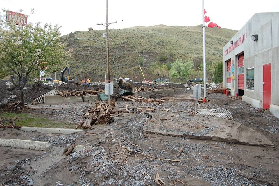 Mud and debris outside the Cache Creek fire hall on May 6, 2023, including ther remains of a wrecked Hesco basket (centre) that was set up to try to protect the hall. (Photo credit: Barbara Roden)