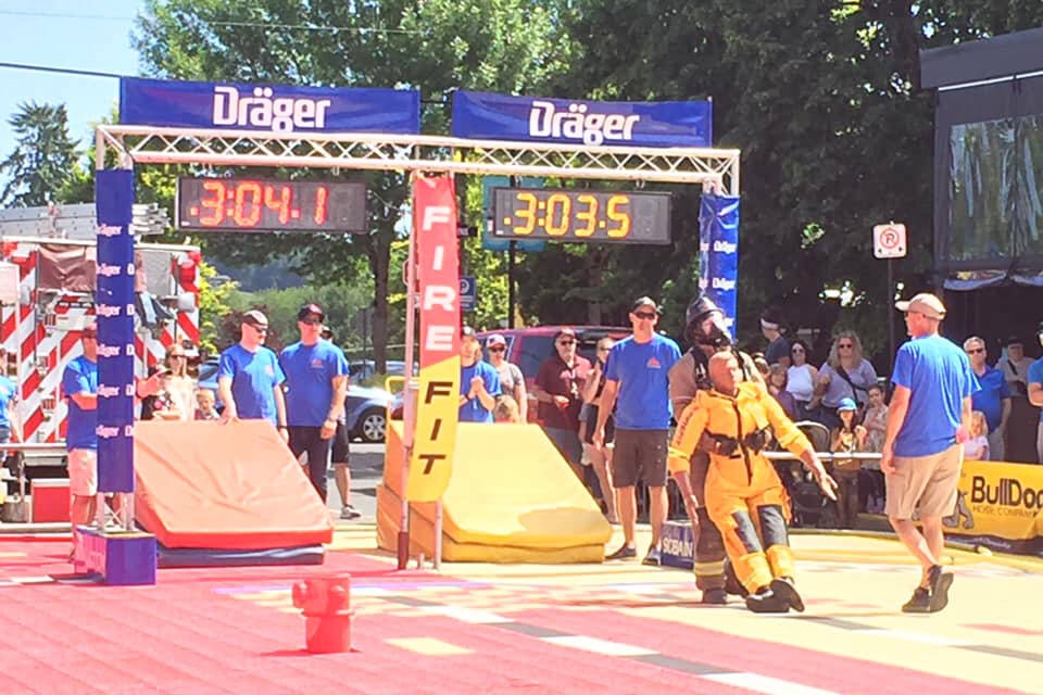 Ashcroft firefighter Greg Hiltz dragging Rescue Randy across the line at the Fire Fit Challenge in Courtenay on May 27. (Photo credit: Vicky Trill)