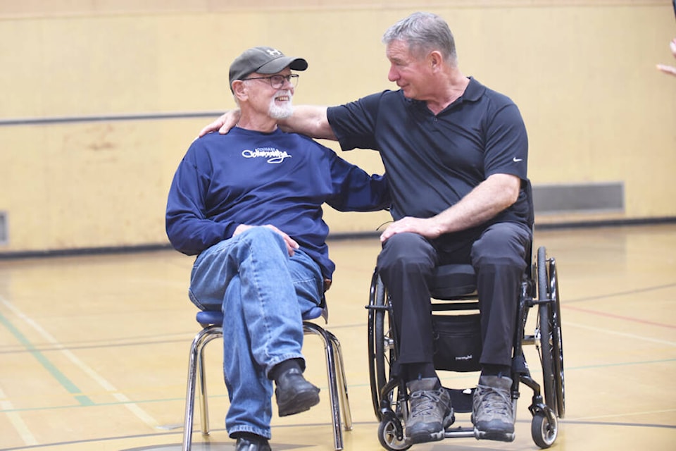 Jack Burgar, retired teacher, reconnects with Rick Hansen, who he coached when Hansen was in high school in Williams Lake. The two reminisced in the Columneetza gymnasium where Hansen was a student athlete and Burgar was a coach. (Ruth Lloyd photo - Williams Lake Tribune)