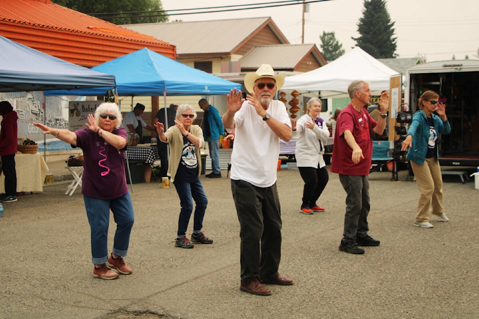 Members of 100 Mile House’s Tai Chi class demonstrate some moves for attendees of the South Cariboo Farmers’ Market. (Patrick Davies photo - 100 Mile Free Press)