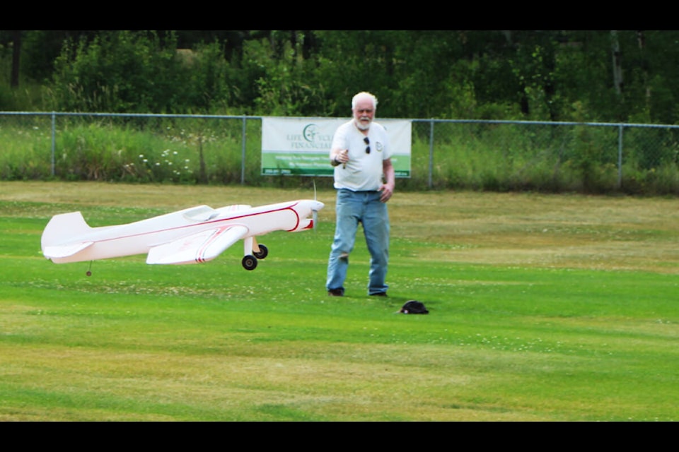 Longtime model plane pilot Larry Lewin demonstrates how to fly a plane using a lead line at the 100 Mile Model Flyers’ annual Fun Fly Day. (Patrick Davies photo - 100 Mile Free Press)