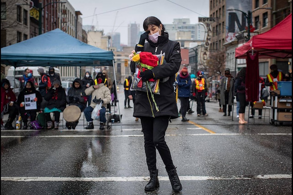 Charlene Brunelle wipes her eye as she listens to people speak about loved ones they have lost, before the annual Women’s Memorial March in Vancouver, B.C., Sunday, Feb. 14, 2021. The march is held to honour missing and murdered women and girls from the community with stops along the way to commemorate where women were last seen or found. THE CANADIAN PRESS/Darryl Dyck