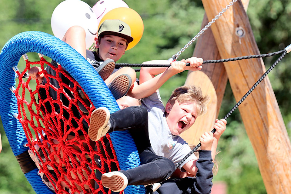 Greenwood Elementary’s Nelson Thompson (Grade 5) and Lincoln Simmonds (Grade 6) take a fun-filled turn on the swing at Lions Park Thursday, June 17. Photo: Laurie Tritschler