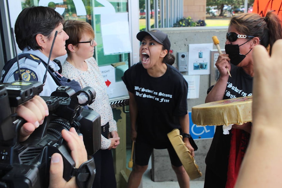 A woman screams in frustration at Campbell River RCMP members during the procession. Photo by Marc Kitteringham / Campbell River Mirror