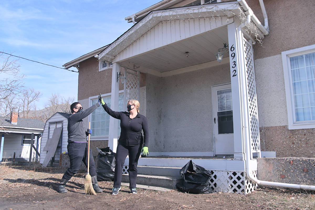 Boundary Helping Hands Zeke Sijohn (left) high-fives Chairperson Kimberly Feeny outside the societys soon-to-be cat shelter on Grand Forks 2nd Street on Thursday, March 4. Photo: Laurie Tritschler