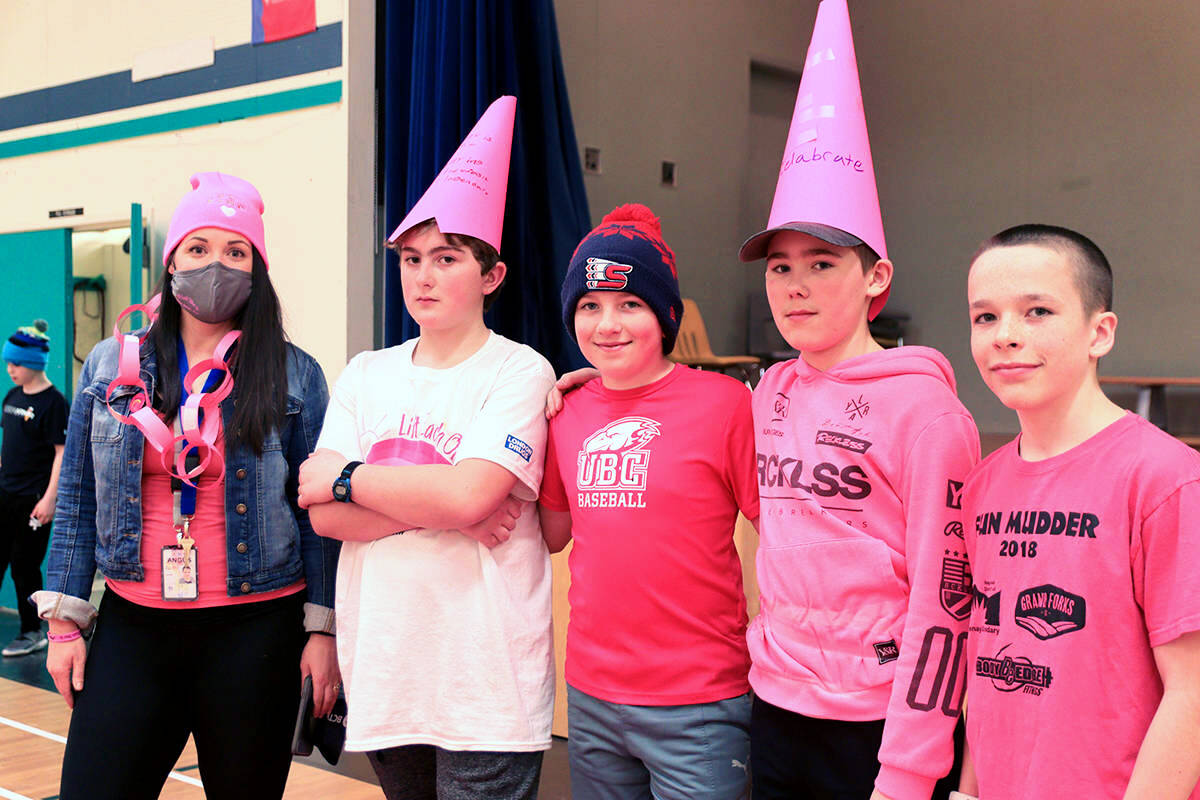 (L-R) Grade 7 teacher Keira Angus poses at Huttons gym with kids Paxton Zorn, Ty McKaig, Gage Kiselbach and Brett Friesen at last years Pink Shirt Day.