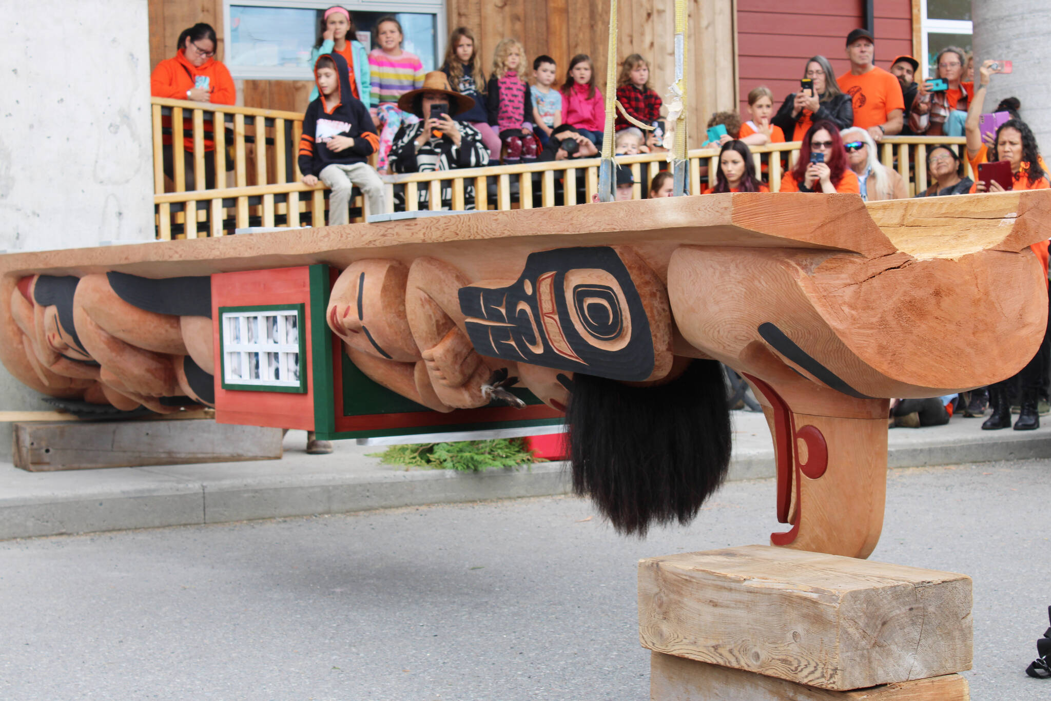 A totem pole raising ceremony at the Kermode Friendship Society building commemorates the legacy of the residential school system. (Michael Bramadat-Willcock/Black Press Media)